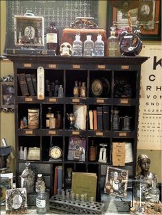 an old fashioned bookcase with many items on it