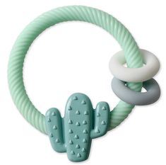 a green and white toy with a cactus on it's side, in the shape of a ring