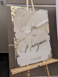 an easel with a sign on it that says just and marygann in gold foil