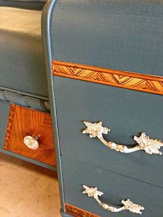 two blue dressers with gold handles on each drawer and one has an ornate design