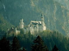 an old castle sits on top of a mountain