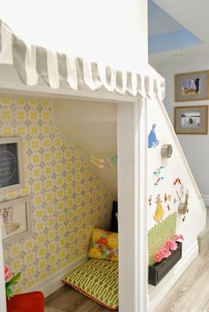 a child's room with a bed under the stairs