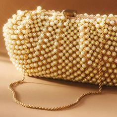 The Santi Gemelli Clutch, Purchased From Anthropologie. Worn Once To A Wedding. In Excellent Condition, Aside From Some Lip Liner Stains Inside (Please See Photo). Adorned With Pearls And Gold Beads, With A Gold Chain Strap Which Is Able To Be Tucked Inside. Silk Interior. Perfect Companion For Weddings. From The Item Listing: Add A Modern Touch To Your Look With This Pearly Silk Clutch, Ideal For Holding The Essentials. Clasp Closure 11"L; 2"W; 5.5"H; 11" Strap Drop Silk, Plastic Beads, Brass I Gold Clutch With Pearl Handle As Fashion Accessory, Glamorous Pearl Clutch With Pearl Handle, Gold Clutch With Pearl Handle, Pearl Chain Gold, Chic Pearl-embellished Clutch For Formal Occasions, Luxury Pearl-embellished Clutch Evening Bag, Anthropologie Bags, Silk Clutch, Summer Wedding Colors