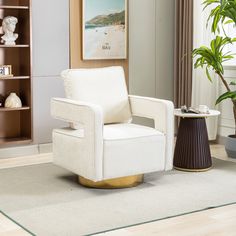 a white chair sitting on top of a wooden floor next to a potted plant