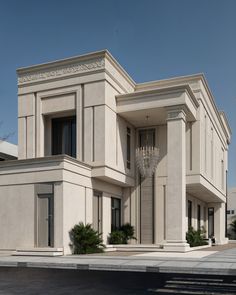 a large white building with a chandelier on the front and side of it