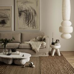 a living room filled with furniture and pictures on the wall above it's coffee table