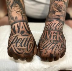 two hands that have tattoos on them with words written in the middle and one hand