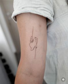 a woman with a tattoo on her arm holding onto a string that is in the shape of a hand