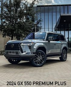 a gray suv parked in front of a building with the words, 2021 6x5 premium plus