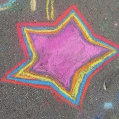 a colorful star drawn in chalk on the ground