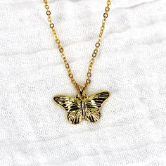 This necklace features a vintage gold plated butterfly pendant threaded on a modern 24k gold plated 16" chain. The necklace is tarnish resistant. Gold Dainty Butterfly Pendant Necklace, Dainty Gold Butterfly Charm Necklace, Dainty Gold Butterfly Necklace With Delicate Chain, Dainty Gold Butterfly Pendant Necklace, Dainty Gold Butterfly Necklace With Charm, Gold Butterfly Charm Pendant Necklace, Gold Charm Necklace With Butterfly Charm As Gift, Gold Plated Butterfly Necklace With Charm, Gold Pendant Necklace With Butterfly Charm