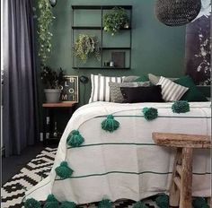 a bedroom decorated in green and white with pom - poms on the bed