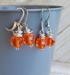 "Transparent Orange Dangle Earrings I initially created these earrings as a statement for Multiple Sclerosis Awareness, a disease which I have battled for eight plus years, but got so many complements from non MS customers, I am sharing it with you all. I am now living back in Charlottesville,VA, UVA territory, go orange! I wire wrapped bright transparent orange faceted fire polished Czech glass beads in antiqued silver plated copper wire. Use the drop box option to choose your preference. Messa Coin Pearl Earrings, Multiple Sclerosis Awareness, Charlottesville Va, Orange You Glad, Orange Earrings, Drop Box, Pearl Leather, Flower Pendant Necklace, Copper Necklace