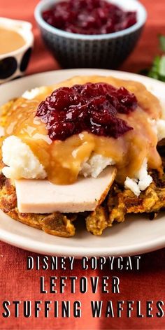 a white plate topped with pancakes covered in cranberry sauce