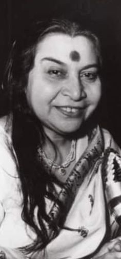 an old black and white photo of a woman with long hair wearing a sari