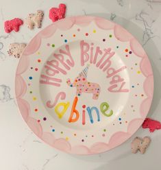 a birthday plate with the words happy birthday abne written on it next to cookies and candies