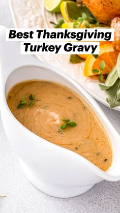 the best thanksgiving turkey gravy is served in a white serving dish with fresh herbs