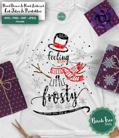 a t - shirt with the words feeling in frosty on it and presents around it