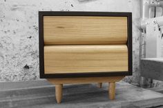 a small wooden cabinet sitting on top of a table