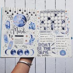 someone holding up a planner with the moon and stars on it