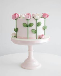 a white cake with pink roses on it