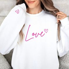 Love Crewneck Sweatshirt What the world needs now, is love sweet love... you know the tune. Try wearing your heart on your sleeve. Made with a medium-heavy fabric that consists of 50% cotton and 50% polyester for that cozy feel and warmth you need in a hoodie. .: The classic fit along with the pouch pocket and the tear-away label make for a highly comfortable, scratch-free wearing experience.  .: Made using 100% ethically grown US cotton. Gildan is also a proud member of the US Cotton Trust Protocol ensuring ethical and sustainable means of production. The blank tee's dyes are OEKO-TEX-certified dyes with low environmental impact. Casual Heart Graphic Sweatshirt Gift, Long Sleeve T-shirt With Heart Graphic For Gift, Heart Graphic Long Sleeve Top As Gift, Long Sleeve Tops With Heart Graphic For Gift, Valentine's Day Gift Top With Long Sleeves, Long Sleeve Tops With Heart Graphic As Gift, Valentine's Day White Crew Neck Sweatshirt, White Crew Neck Sweatshirt For Valentine's Day, Valentine's Day White Casual Sweatshirt