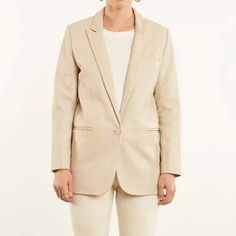 Step up your fashion game with our Off-White Lambskin Leather Blazer for Women. Made with high-quality lambskin leather, this blazer is the perfect addition to any stylish wardrobe. This blazer will make you feel confident, powerful, and stylish. You will turn heads wherever you go and feel comfortable while doing it. Whether you're attending a formal event or just running errands, this blazer will make you feel put together and ready to take on the world. Feel confident and powerful with this c Sleek White Office Blazer, Beige Leather Jacket For Work, Chic Beige Leather Jacket For Work, Chic Beige Leather Jacket For Office, Cream Leather Outerwear For Work, Spring Cream Business Blazer, Cream Business Blazer For Spring, Beige Leather Blazer For Office, Classic Beige Leather Jacket For Work