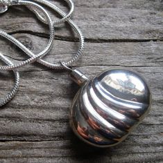 DESCRIPTION: I am kind of obsessed with these old Taxco perfume and snuff bottle pendants. I am very intrigued by secret compartments and hidden aspects. This is a heavy gorgeous sterling silver pendant that carries your favorite scent, your essential oils or whatever you want to carry. Or just wear it because it's old and beautiful and very cool! I have cleaned but not polished this piece, but it will polish up beautifully if you like your sterling shiny. This kind of vintage quality is why we love it so much...heavy sturdy chunky silver, handmade artisan craftsmanship and distinctive design. You will love this piece. I have paired this vintage pendant with a nice new chunky 3mm chain, which sets it off very nicely. And the chain also works on it's own for a whole other look..or with your Snuff Bottle, Favorite Scents, Schmuck Design, Snake Chain, Amazing Jewelry, Sterling Silver Pendants, Silver Pendant, Jewelry Necklace Pendant, Perfume Bottles