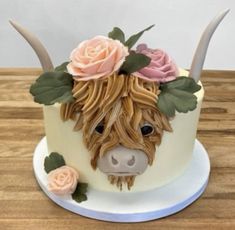 a cake decorated to look like a cow with horns and flowers on it's head