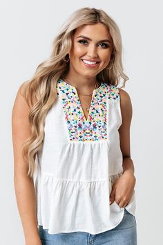 Liven up your wardrobe with our adorable white 'Tahitian Gardens' top featuring lightweight material with colorful embroidered detailing across the bodice and shoulders, a sleeveless fit with a v-notch neckline, and a relaxed silhouette that falls into a peplum bottom with an uneven hemline! Impressions Online Boutique, Embroidered Top, Online Boutique, Floral Tops, Bodice, Wardrobe, Floral, Women's Top, White