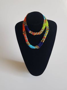 This necklace is 100% handcrafted using colorful fine beads. The necklace makes a perfect gift to loved ones. **Buy multiple items and pay shipping for 1 item only.The rest ships free. Custom orders are welcome. More neckleces here; https://www.etsy.com/shop/TribalTess?ref=seller-platform-mcnav&section_id=21306083 Back to my shop; https://www.etsy.com/shop/TribalTess?ref=seller-platform-mcnav Handmade Multicolor Long Bead Necklace, Unique Multicolor Long Beaded Necklace, Multicolor Necklace With 108 Beads For Festivals, Unique Orange Beaded Necklace With Colorful Beads, Unique Orange Beaded Necklace, Traditional Colorful Beaded Necklaces As Gift, Adjustable Multicolor Necklace With 108 Beads, Multicolor Long Necklace With Tiny Beads, Long Multicolor Necklace With Tiny Beads