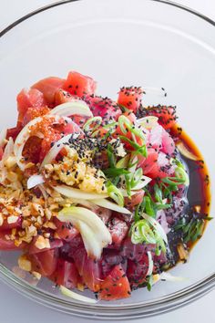 a glass bowl filled with different types of food