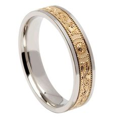 a wedding ring with an intricate design on the side and gold inlaying it