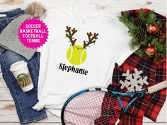 a t - shirt with reindeer antlers on it and tennis racket next to it