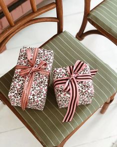 two wrapped presents sitting on top of a chair