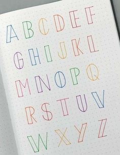 an open notebook with colorful letters on it