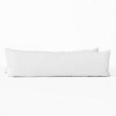 two white pillows sitting on top of each other