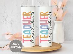 two personalized tumbles sitting on a plate with flowers in the background and text that reads teacher