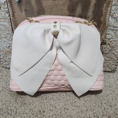 Brand New Betsy Johnson Purse. Lost Price Tag But Ring That Connects Tag Is Still Attached. Pink, White And Gold. Perfect Condition. Smoke Free Home. Trendy White Bag With Bow, Trendy White Shoulder Bag With Bow, Cute White Shoulder Bag For Party, White Everyday Bags With Bow Detail, Feminine White Bag With Detachable Strap, Feminine White Shoulder Bag For Everyday Use, Feminine White Shoulder Bag As Gift, Feminine White Shoulder Bag For Everyday, Feminine White Bag For Party