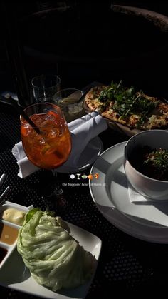 a table topped with plates and bowls filled with food covered in sauces next to drinks