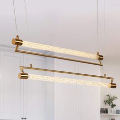 three lights hanging from the ceiling in a kitchen