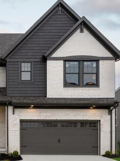 a large house with two garages in the front and one on the other side