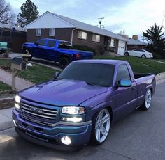 a purple truck parked in front of a house