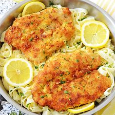 chicken schnitz with lemons and pasta in a pan