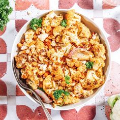 a bowl filled with cauliflower and broccoli on top of a table