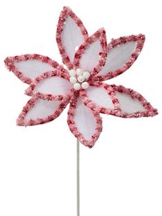 a pink and white flower on a stick