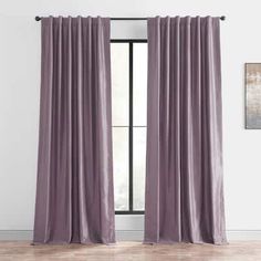 an open window with purple curtains hanging on the wall and wooden floors in front of it