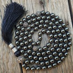 "📿This Balancing Mala is hand-knotted with the finest Hematite Beads. Each Bead is mindfully knotted with love, one at a time on a durable nylon silk cord for extra strength and durability. This Mala features all 108 beads divided by markers into sections of beads that follow a selected pattern. Each section is marked with an Oxidized Silver Metal Marker Bead. It is finished with a Silk Tassel adorned with silver Zari. The tassel symbolises consciousness and oneness. This Mala helps varying ene Silver Beaded Necklace With Round Beads, Silver Beaded Spiritual Mala, Silver Mala With 108 Beads For Meditation, Silver Beaded Necklace For Meditation With 8mm Beads, Hematite Beads For Gifts, Black Beads Mala For Meditation, Black Beaded Mala For Meditation, Hematite Round Beads Jewelry For Meditation, Hematite Beaded Necklaces As Gift