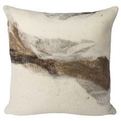 a white and brown pillow with an abstract design on the front, sitting against a white background