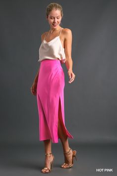 Description: The Sleek Satin Side-Slit Midi Skirt is the epitome of understated elegance, perfect for adding a touch of sophistication to your wardrobe. Crafted from a blend of 97% polyester and 3% spandex, this skirt offers a smooth, luxurious feel with just the right amount of stretch for comfort. The medium-weight satin fabric drapes beautifully, while the side slit adds a hint of allure and ease of movement. A discreet side zipper ensures a secure fit, making this skirt both practical and st Pink Satin Skirt Outfit, Pink Satin Skirt, Pink Skirt Outfits, Satin Skirt Outfit, Bright Winter, Draped Skirt, Satin Midi Skirt, Satin Skirt, Pink Skirt